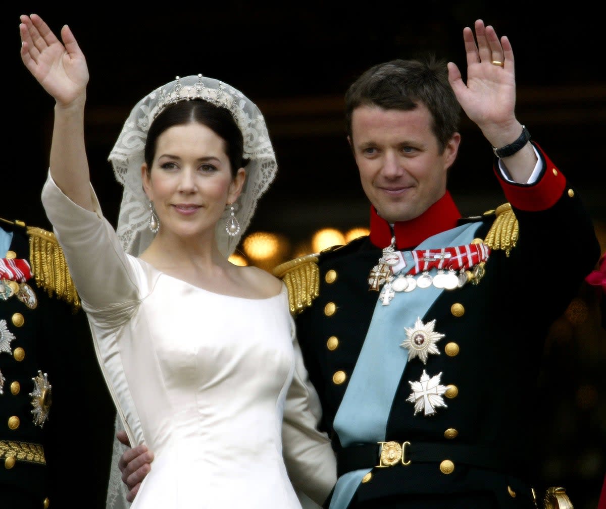 Crown Princess Mary and Crown Prince Frederik of Denmark wave from the balcony of Christian VII’s Palace after their wedding on 14 May 2004 in Copenhagen, Denmark (Getty Images)