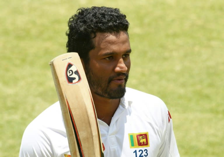 Sri Lanka's Dimuth Karunaratne celebrates reaching his half century on the fourth day of the second Test against Zimbabwe in Harare on November 9, 2016