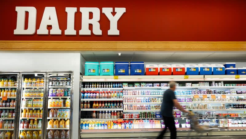 A patron passes the dairy section while grocery shopping at Ream's in Sandy on Wednesday, Jan. 31, 2024.