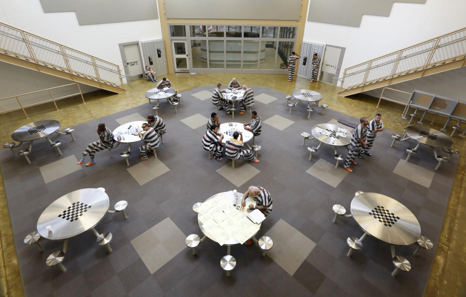 FILE - In this March 25, 2014, file photo, inmates gather in the common room at the new 192-bed facility at the Stanislaus County Jail in Modesto, Calif. An advisory committee to Gov. Gavin Newsom says California should allow all but death row inmates and those serving life-without-parole to request lighter sentences after serving at least 15 years. (AP Photo/Rich Pedroncelli, File)