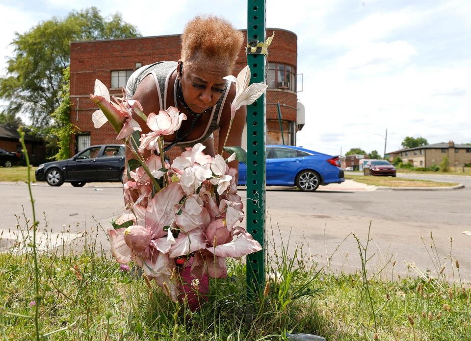 Debra Davis, 61 of Detroit, was watching the Detroit Police Department press conference and decided to come to Joy Road and Marlowe Street to put down flowers and pay her respects to officer Loren Courts on Thursday, July 7, 2022 in Detroit. Courts was a five-year veteran of the  Detroit Police Department who was shot and killed by a man with an assault rifle on Wednesday evening.