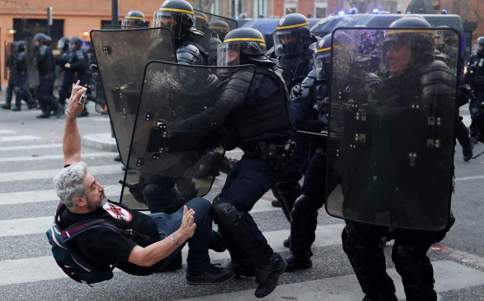 French Republican Security Corps police officers in riot gear clash with a protestors in Toulouse - CHARLY TRIBALLEAU/AFP via Getty Images