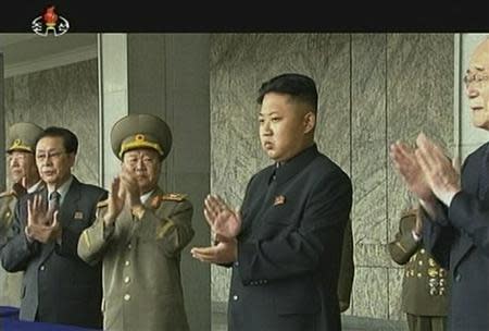 North Korea's leader Kim Jong-un claps during a parade marking the 1948 establishment of North Korea, in Pyongyang in this still image taken from video released by KRT, North Korean state TV on September 9, 2013. REUTERS/KRT via Reuters TV