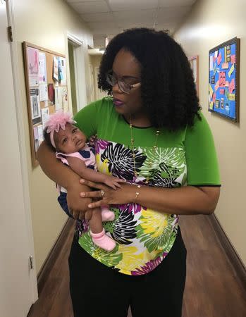 Dr. Nicole Arthur holds Karlee J. Scott, who was born in April 2017 in Bay Minette, Alabama, U.S. on June 22, 2017. REUTERS/Jilian Mincer