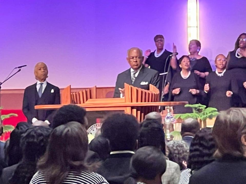 Rev. Al Sharpton, left, listens as Rev. Dwight Jones, senior pastor of First Baptist Church of South Richmond, opens the memorial service for Irvo Otieno.