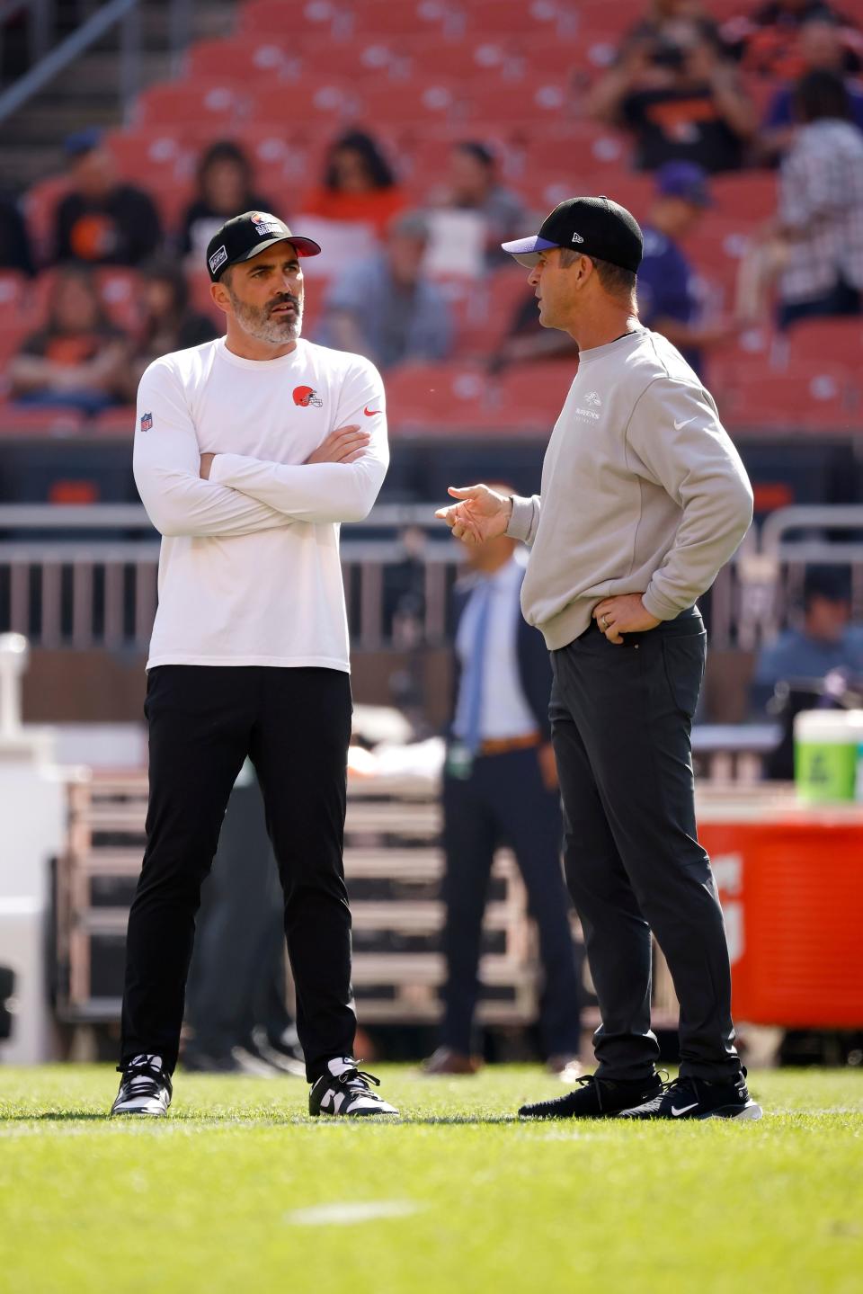 Browns coach Kevin Stefanski and Ravens coach John Harbaugh talk before the start of a game Oct. 1 in Cleveland.