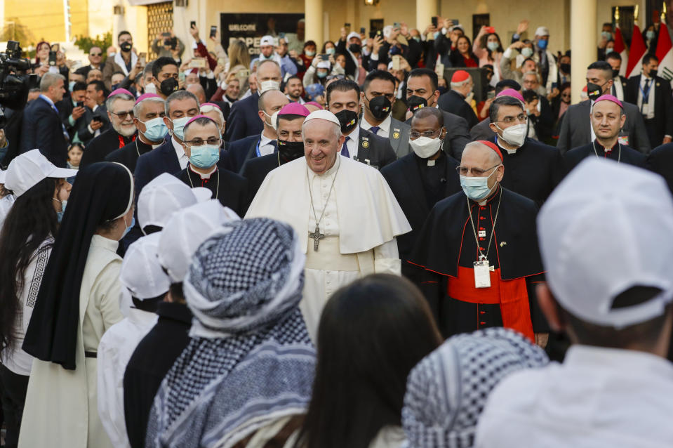 Pope Francis, center arrives to concelebrate a mass in the Chaldean Cathedral of Saint Joseph, in Baghdad, Iraq, Saturday, March 6, 2021. Earlier today Francis met privately with the country's revered Shiite leader, Grand Ayatollah Ali al-Sistani. (AP Photo/Andrew Medichini)