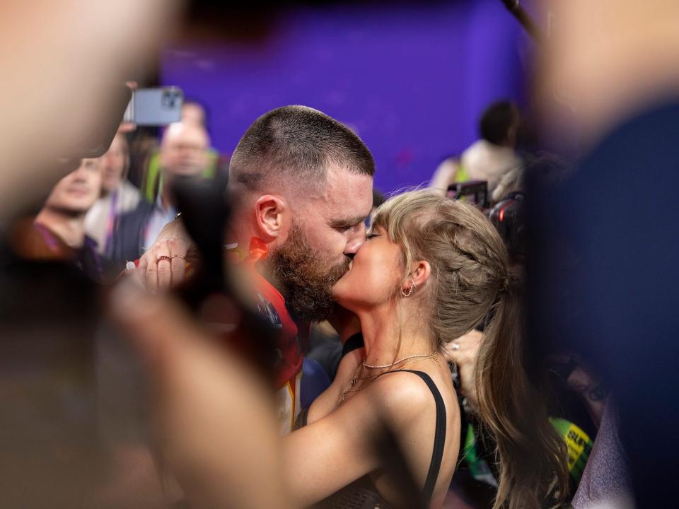 Travis Kelce kisses Taylor Swift following Super Bowl win.