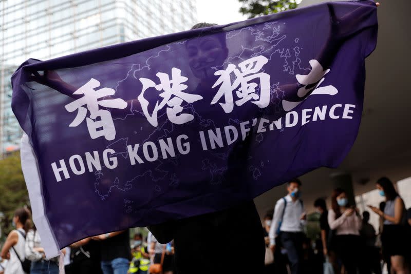 A pro-democracy demonstrator holds a flag supporting Hong Kong Independence during a protest to mark the first anniversary of a mass rally against the now-withdrawn extradition bill, in Hong Kong