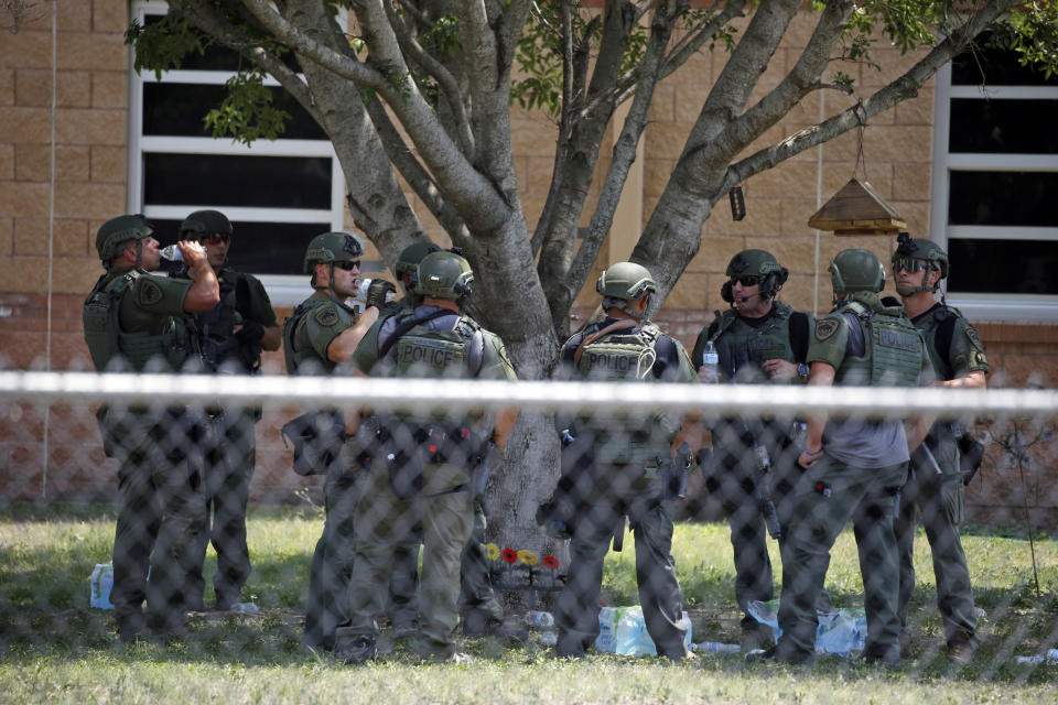 FILE - Law enforcement personnel stand outside Robb Elementary School following a shooting, Tuesday, May 24, 2022, in Uvalde, Texas. (AP Photo/Dario Lopez-Mills, File)