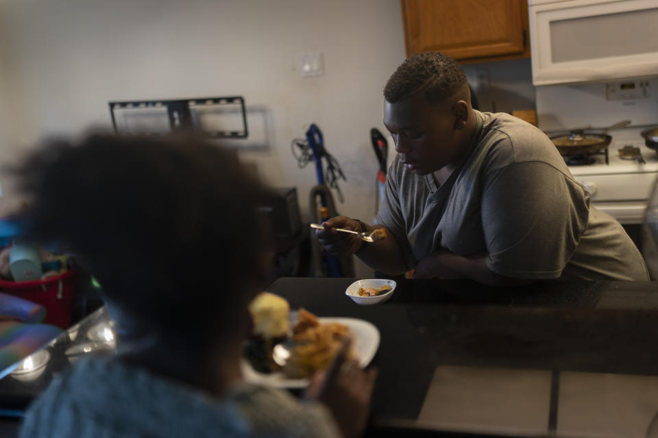 John Simon, a teenager who had a bariatric surgery in 2022, eats out of a small bowl to control his calorie intake in Los Angeles, Monday, March 13, 2023. (AP Photo/Jae C. Hong)