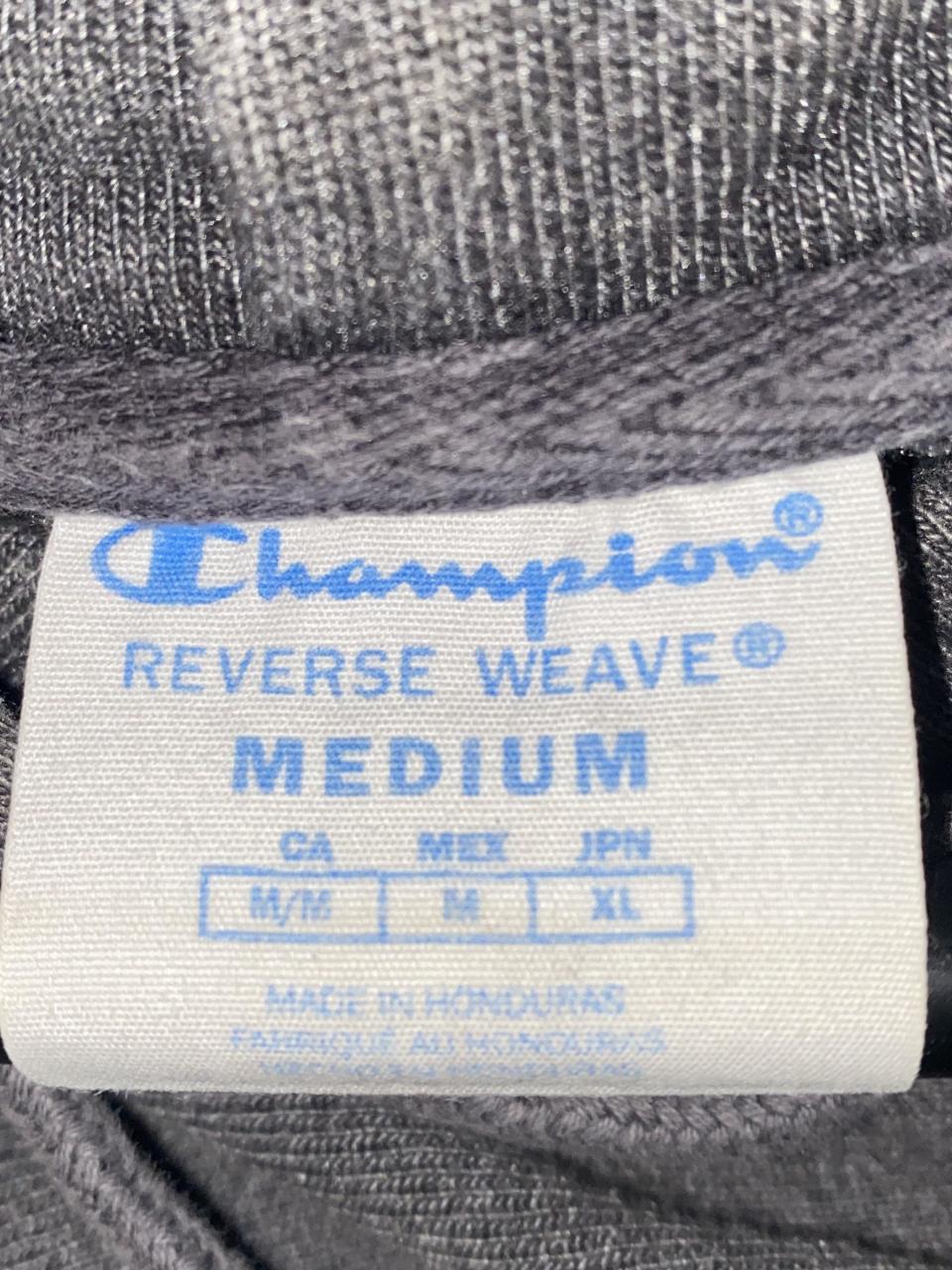 Label of a medium Champion shirt showing it's M/M in Canada, M in Mexico, and XL in Japan