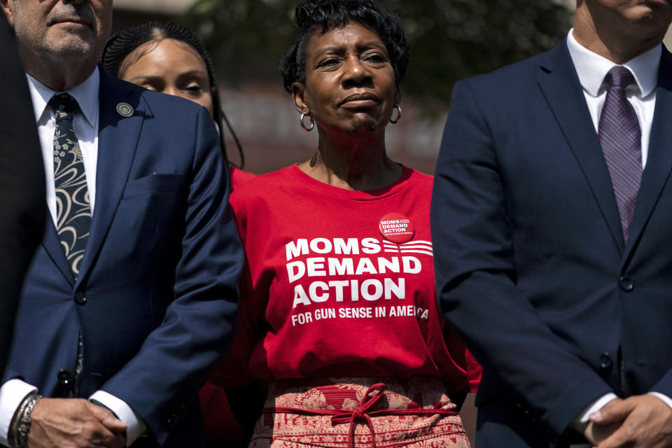Arvis Jones, center, whose son was killed in gun violence in 2008, attends a news conference by California Gov. Gavin Newsom in Santa Monica, Calif., Friday, July 22, 2022. Newsom signed a new gun control law Friday, a month after conservative justices overturned women's constitutional right to abortions and undermined gun control laws in states including California. (AP Photo/Jae C. Hong)