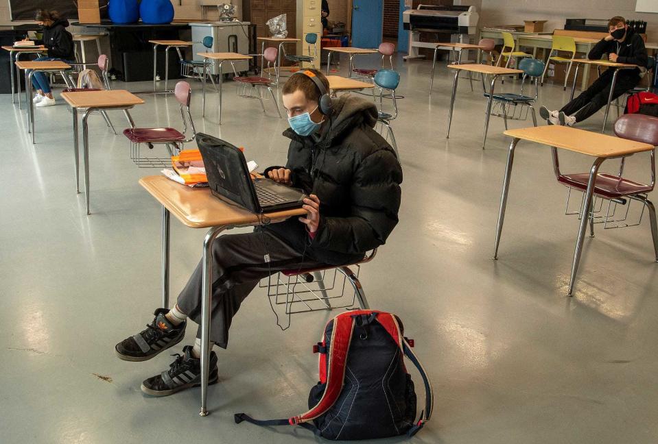 Students wearing masks attend in-person class in December 2020 at David Prouty High School in Spencer.