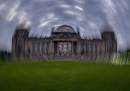 Picture taken while turning the camera shows the Reichstag building with the German parliament in Berlin, Germany, Sunday, Sept. 26, 2021. German elections are held on Sunday. (AP Photo/Michael Probst)