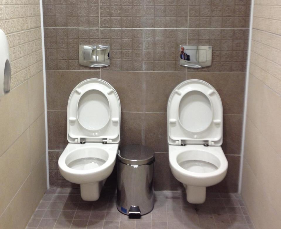 ALTERNATIVE CROP TO LON110 This photo taken on Friday Jan. 17, 2014, shows two toilets at the cross-country skiing and biathlon center for next monthÌs Olympics in Sochi, Russia. Although two toilets and only one stall like this are not common in Russia, social media users have responded by posting other pictures of toilets standing side by side. One said this was standard at Russian soccer stadiums. (AP Photo/Steve Rosenberg, BBC)