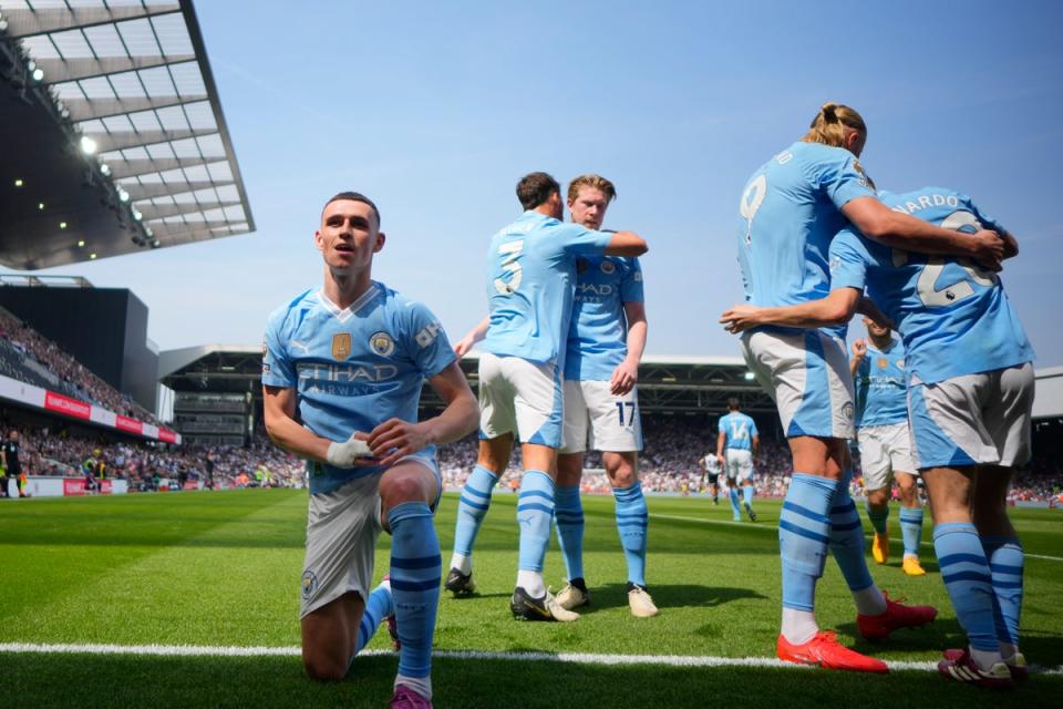 Phil Foden celebrates after another goal (AP)