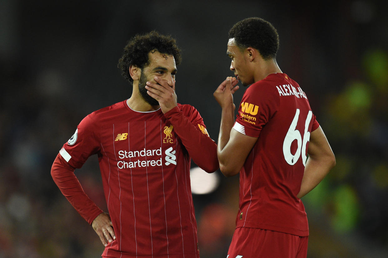 Liverpool's Egyptian midfielder Mohamed Salah (L) discusses with Liverpool's English defender Trent Alexander-Arnold during the English Premier League football match between Liverpool and Norwich City at Anfield in Liverpool, north west England on August 9, 2019. (Photo by Oli SCARFF / AFP) / RESTRICTED TO EDITORIAL USE. No use with unauthorized audio, video, data, fixture lists, club/league logos or 'live' services. Online in-match use limited to 120 images. An additional 40 images may be used in extra time. No video emulation. Social media in-match use limited to 120 images. An additional 40 images may be used in extra time. No use in betting publications, games or single club/league/player publications. /         (Photo credit should read OLI SCARFF/AFP/Getty Images)