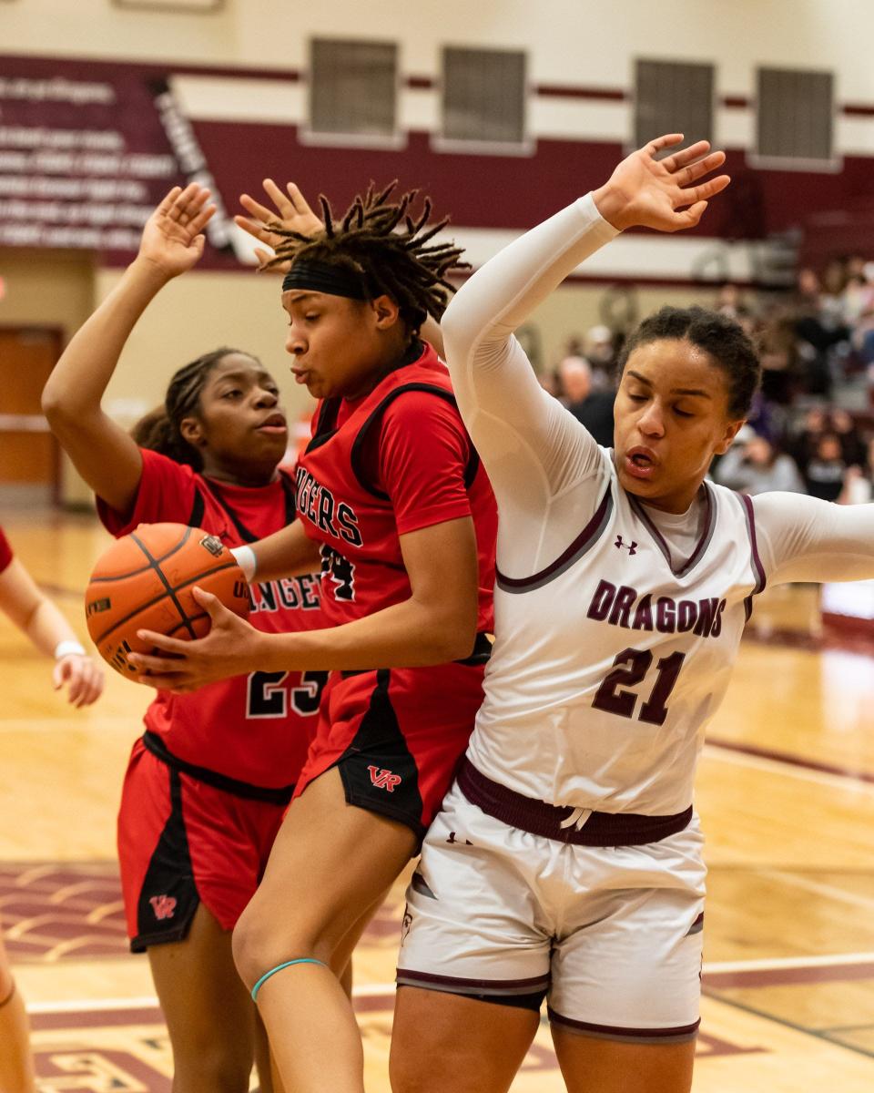 Kianna Wormly pulls down a rebound for Vista Ridge in a battle with Round Rock's Bailey Featherstone as Nadia Adeleke closes in. Wormley led all scorers with 24 points and collected 14 rebounds. Featherstone had a team-high 15 points.