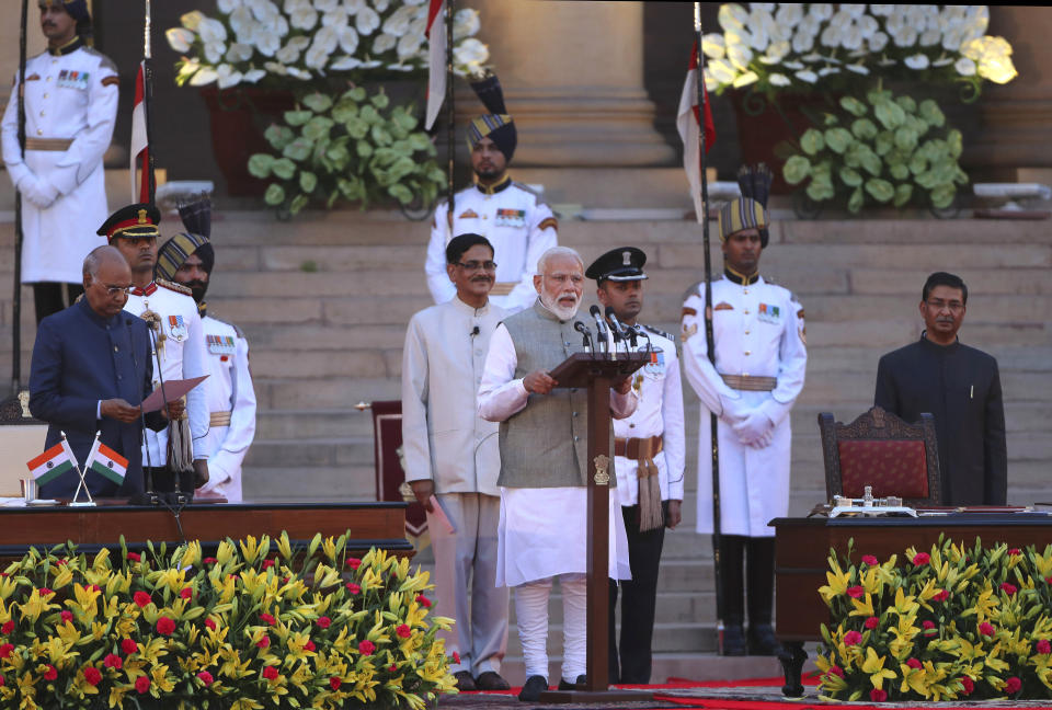 FILE- Indian President Ram Nath Kovind, left, administers oath to Narendra Modi, center, for a second term as India's prime minister during a swearing in ceremony at the presidential palace in New Delhi, India, May 30, 2019. Modi is campaigning for a third term in the general election starting Friday. (AP Photo/Manish Swarup)