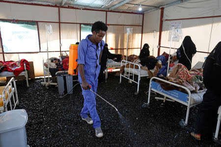 A worker sprays pesticides inside a tent where patients receive medical care at a cholera treatment center in Sanaa, Yemen March 10, 2019. Picture taken March 10, 2019. REUTERS/Khaled Abdullah