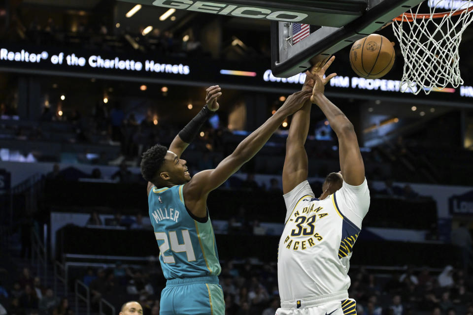 Charlotte Hornets forward Brandon Miller (24) blocks a shot by Indiana Pacers center Myles Turner (33) during the first half of an NBA basketball game, Sunday, Feb. 4, 2024, in Charlotte, N.C. (AP Photo/Matt Kelley)