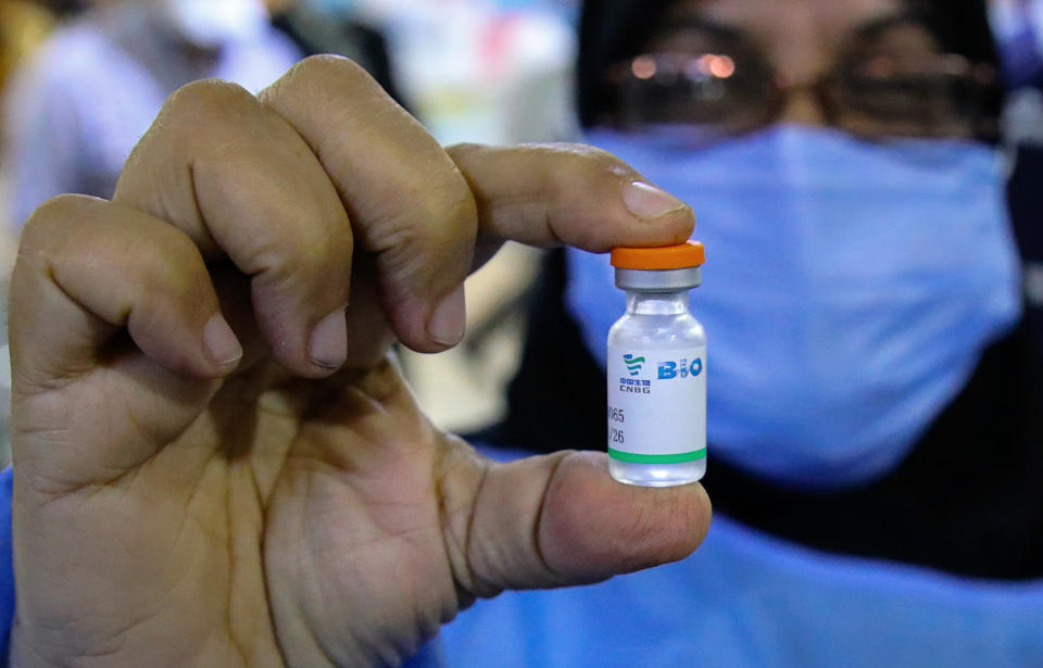 A health worker holds a vial of the Sinopharm coronavirus vaccine during the vaccination of health personnel, at a clinic in Basra, Iraq, Wednesday, March 3, 2021. (AP Photo/Nabil al-Jurani)