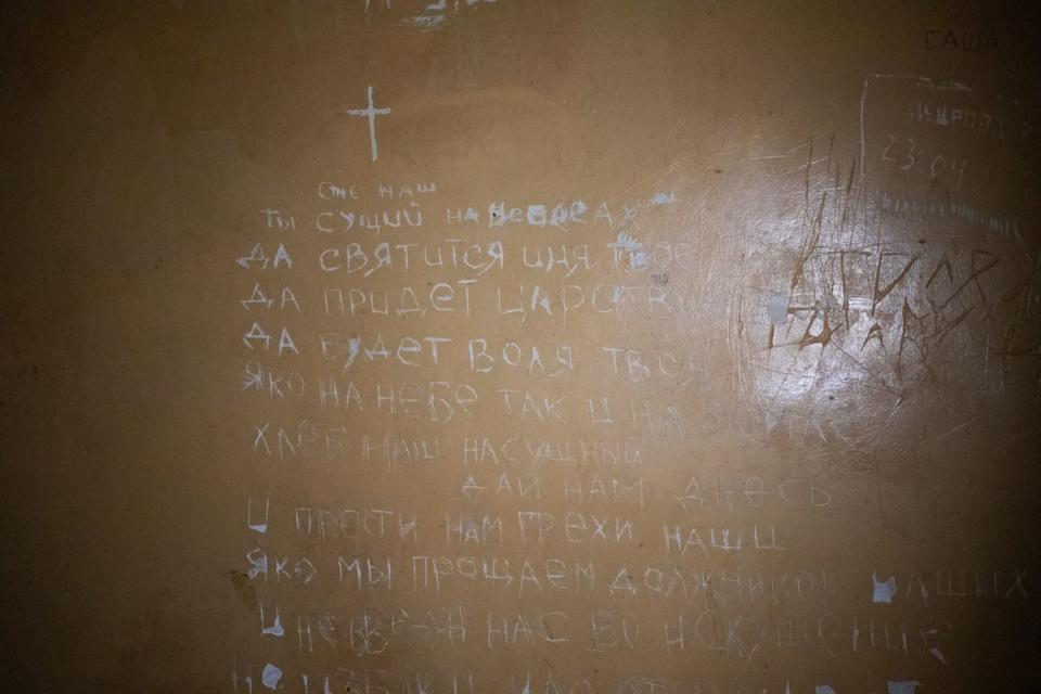 <div class="inline-image__caption"><p>The Lord’s Prayer carved into holding cells in the police station turned torture chamber in Balakliya.</p></div> <div class="inline-image__credit">Tom Mutch</div>
