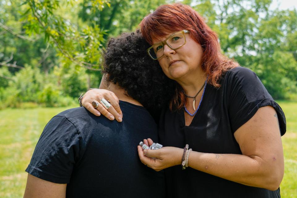 Amy Figgs, right, embraces her son, Leo Figgs, while holding some of Leo’s empty testosterone vials on Saturday, July 29, 2023, in Lexington, Ky.