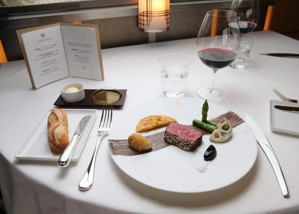 <p>Guests aboard the Train Suite Shiki-shima can select from a menu devised by a Michelin-starred chef. (Photo: Asahi Shimbun via Getty Images) </p>