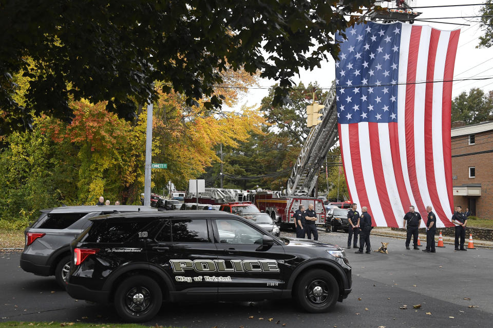 FILE - Police officers from Bristol, Conn. gather with other towns at the scene where two police officers killed, Thursday, Oct. 13, 2022, in Bristol, Conn. The deaths of two Connecticut police officers and the wounding of a third during an especially violent week for police across the U.S. fit into a grim pattern, law enforcement experts say. Even as the number of officers has dropped in the past two years, the number being targeted and killed has risen. (AP Photo/Jessica Hill, File)