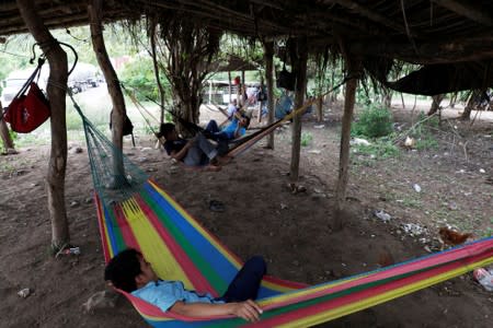 Members of the Community Police rest on hammocks are seen at a checkpoint in the municipality of San Diego Xayakalan