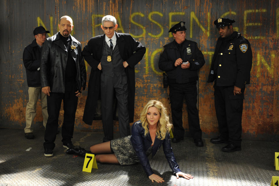 Jenna on the ground in front of the cast of Law and Order: SVU