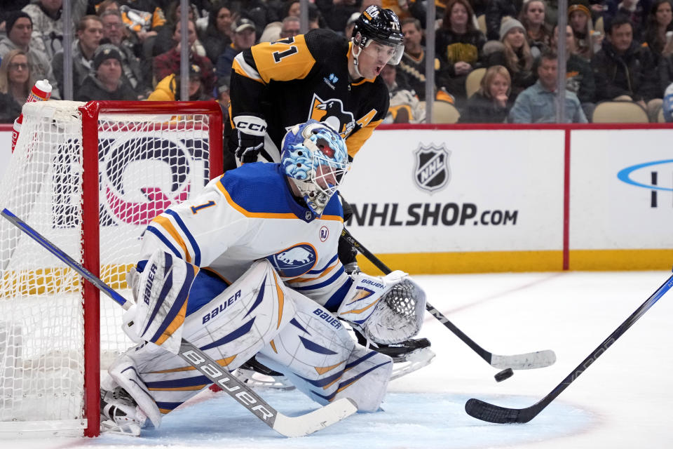 Pittsburgh Penguins' Evgeni Malkin (71) gets off a pass behind Buffalo Sabres goaltender Ukko-Pekka Luukkonen (1) during the second period of an NHL hockey game in Pittsburgh, Saturday, Nov. 11, 2023. (AP Photo/Gene J. Puskar)