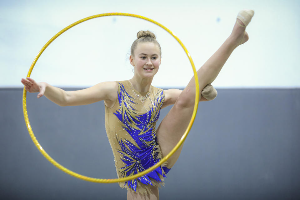 Sara Becarevic performs a gymnastics routine in Visoko, Bosnia, Wednesday, Dec. 1, 2021. In Bosnia, a poor, Balkan country which habitually marginalizes people with disabilities, a soon-to-be-14-year-old girl, born without her lower left arm, pursues her dream of becoming an internationally recognized rhythmic gymnast. Sara Becarevic says she got enchanted with the demanding sport as a toddler, while watching the world championships on television. (AP Photo)