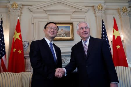 Secretary of State Rex Tillerson greets Chinese State Councilor Yang Jiechi at the State Department in Washington, U.S., February 28, 2017. REUTERS/Aaron P. Bernstein