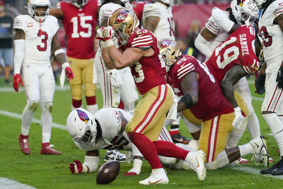 San Francisco 49ers running back Christian McCaffrey, center, celebrates after scoring against the Arizona Cardinals during the second half of an NFL football game Sunday, Dec. 17, 2023, in Glendale, Ariz. (AP Photo/Matt York)