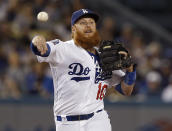 Los Angeles Dodgers third baseman Justin Turner throws out Colorado Rockies' Nolan Arenado on a ground ball during the first inning of a baseball game in Los Angeles, Tuesday, Sept. 18, 2018. (AP Photo/Alex Gallardo)