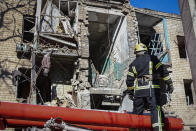 A Ukrainian Emergency Service rescuer works on a building damaged by shelling in Kramatorsk, Donetsk region, Ukraine, Tuesday, March 14, 2023. One person has been killed, according to local authorities. (AP Photo/Roman Chop)