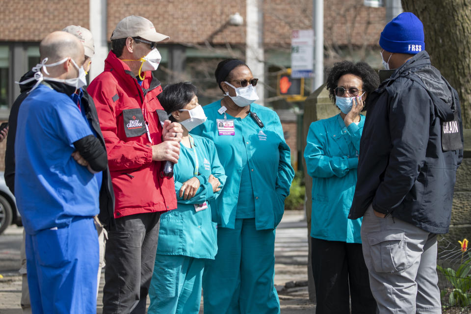 Medical personnel talk to chaplains, left, as they tour the Samaritan's Purse 68 bed emergency field hospital especially equipped with a respiratory unit in New York's Central Park, Tuesday, March 31, 2020, in New York. The new coronavirus caueses mild or moderate symptoms for most people, but for some, especially older adults and people with existing health problems, it can cause more severe illness or death. (AP Photo/Mary Altaffer)