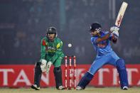 India’s Virat Kohli, right, plays a shot as Bangladesh’s wicketkeeper Anamul Haque watches during the Asia Cup one-day international cricket tournament between them in Fatullah, near Dhaka, Bangladesh, Wednesday, Feb. 26, 2014. (AP Photo/A.M. Ahad)