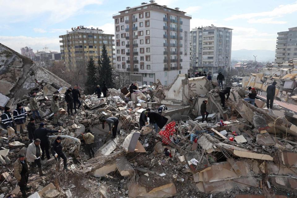 Civilians look for survivors under the rubble of collapsed buildings in Kahramanmaras, Turkey , close to the 7.8 magnitude quake's epicentre, on Tuesday (AFP via Getty Images)