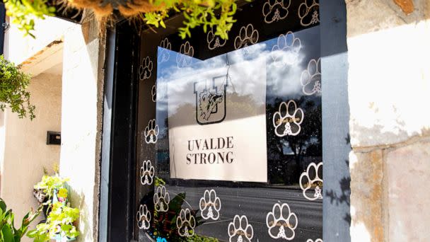 PHOTO: A sign with the 'Uvalde Strong' message and a Uvalde High School Coyote logo is displayed on the window of a building in downtown Uvalde, Texas, on Aug. 21, 2022 (Kat Caulderwood/ABC News)
