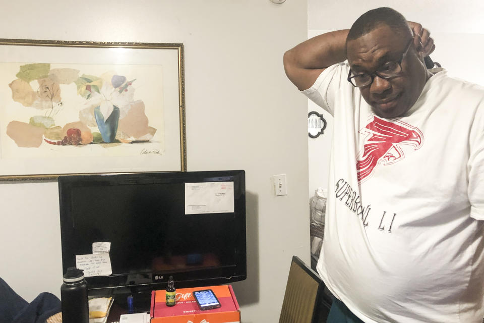 Armetrius Neason poses for a photo inside his room at the Efficiency Lodge hotel outside Atlanta on March 16, 2021. Neason has lived at the hotel for more than five years, but was told during the pandemic he had fallen behind on rent and could be immediately locked out. (AP Photo/Sudhin S. Thanawala)