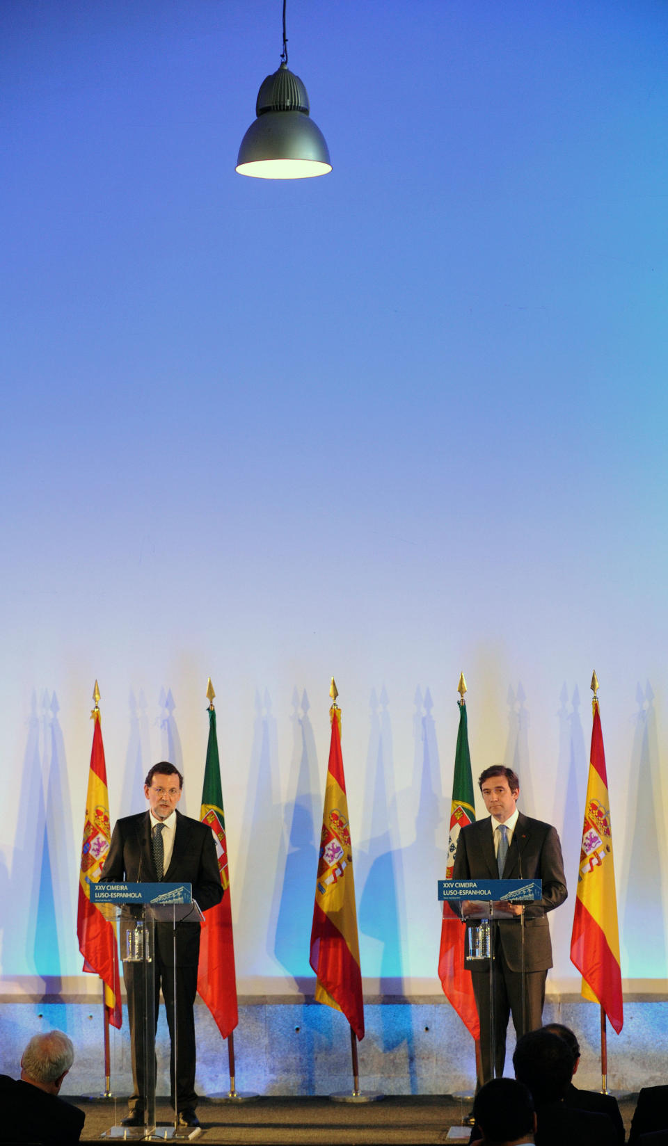 Spain's Prime Minister Mariano Rajoy, left, reacts with his Portuguese counterpart Pedro Passos Coelho during a joint news conference at the annual Portugal-Spain summit Wednesday, May 9 2012, at the Customs House in Porto, Portugal. The annual summit brings together the two prime ministers of Portugal and Spain. Youth employment and ways to create jobs and to reactivate the economy were some of the main topics for both countries that registered some of the highest unemployment rate of the region. (AP Photo/Paulo Duarte)