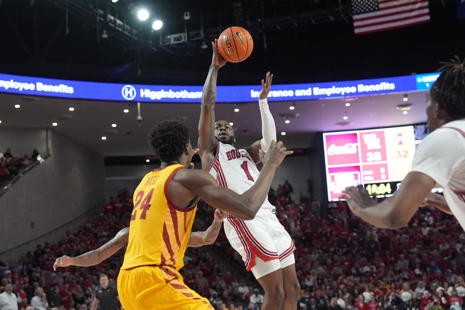 Houston's Jamal Shead (1) shoots as Iowa State's Hason Ward (24) defends during the second half of an NCAA college basketball game Monday, Feb. 19, 2024, in Houston. Houston won 73-65. (AP Photo/David J. Phillip)