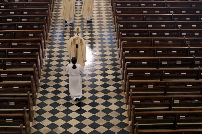 FILE - Archbishop Gregory Aymond conducts the procession to lead a live streamed Easter Mass in St. Louis Cathedral in New Orleans, Sunday, April 12, 2020. The FBI has opened a widening investigation into Roman Catholic sex abuse in New Orleans, looking specifically at whether priests took children across state lines to molest them. The FBI declined to comment, as did the Louisiana State Police, which is assisting in the inquiry. The Archdiocese of New Orleans declined to discuss the federal investigation. "I'd prefer not to pursue this conversation," Aymond told AP. (AP Photo/Gerald Herbert, File)