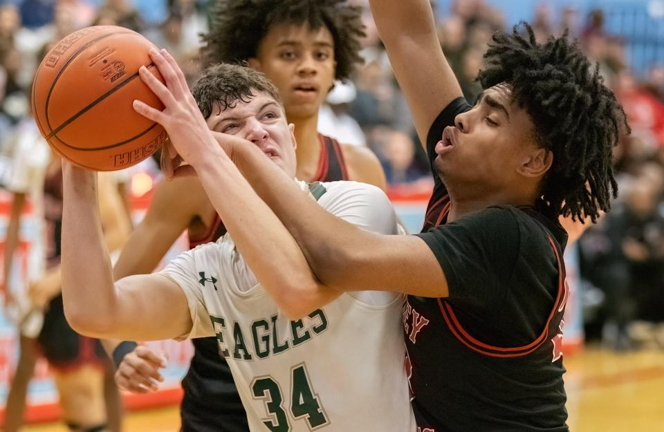 GlenOak’s Reese Zerger is fouled by McKinley’s Jaylen Heard during a district semifinal, Thursday, March 7, 2024.