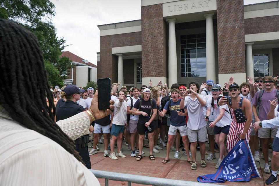 A pro-Palestinian demonstrator records counterprotesters with her phone. (Antonella Rescigno / The Daily Mississippian via AP)