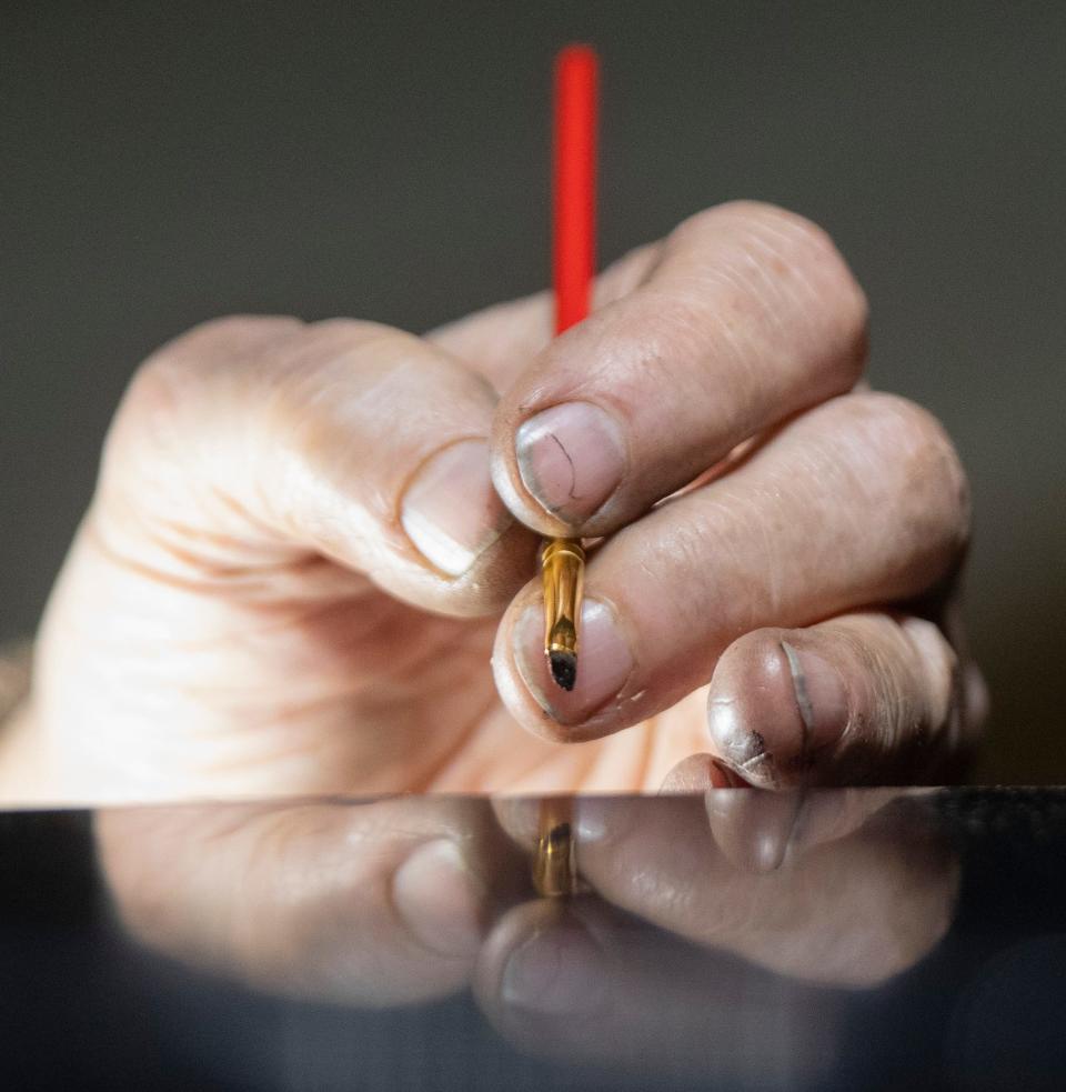 John Mills works on the stain of a piano, Wednesday, Nov. 9, 2022, at Northside Music Company in Lafayette, Ind. 